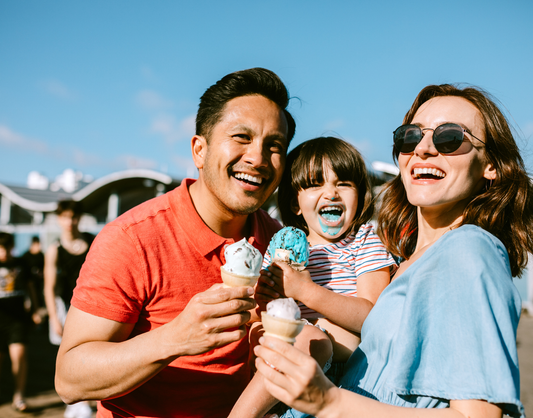 Food for Thought Therapy | 6 Fun Food-Related Activities to do at Home This Summer | Color image of man, woman, and child eating ice cream together and smiling